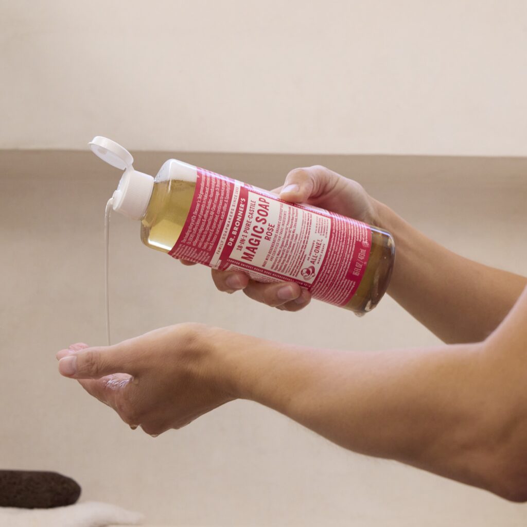 hand holding magic soap bottle in shower