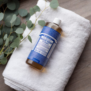 Dr. Bronner's Castile Magic Soap on a towel on the floor.