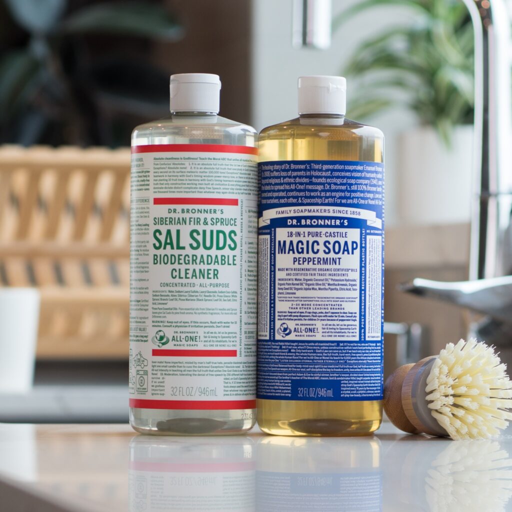 Dr. Bronner's Sal Suds and Castile Magic Soap next to sink in kitchen.