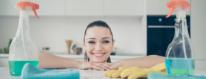 Woman with cleaning supplies.