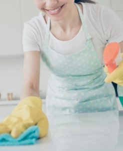 Woman with cleaning supplies.