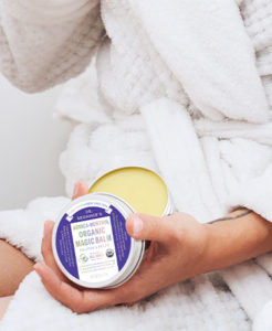 Dr. Bronner's Arnica-Menthol Magic Balm held in someone's hand.