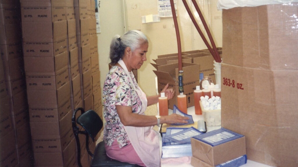 Woman hand filling and labeling Dr. Bronner's Castile Soaps - Dr. Bronner's company location history
