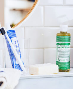 Dr. Bronner's Castile Soap and toothpaste on bathroom counter