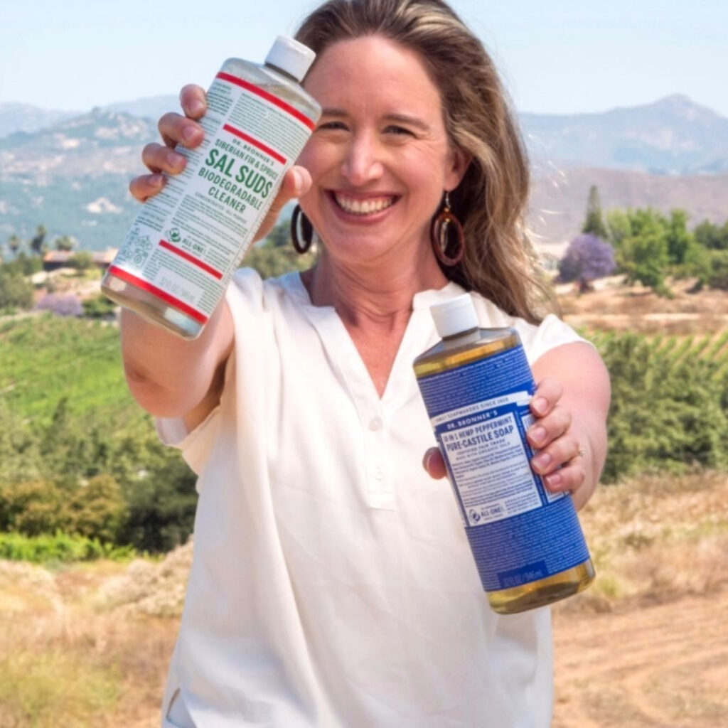 Lisa Bronner holding Dr. Bronner's Castile and Sal Suds.