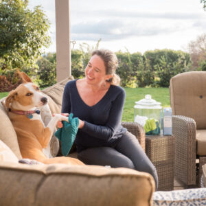 Lisa Bronner using a pet wipe made with Dr. Bronner's Castile Soap on a dog