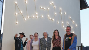 Bronner family and previous owners of the Bronner Haus building stand in front of the "All-One" constellation in Laupheim, Germany