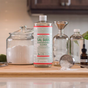 Dr. Bronner's Sal Suds on counter with other cleaning items around it.