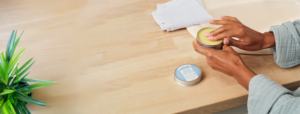 Hands holding the magic balm.