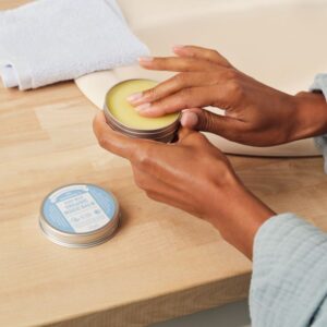 Hands holding the magic balm.