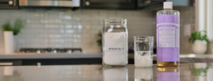 Dr. Bronner's Castile soap and Epsom salt sitting on counter.