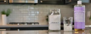 Dr. Bronner's Castile soap and Epsom salt sitting on counter.