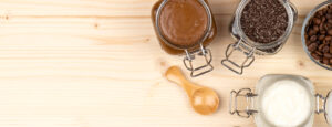 GIY Body Scrubs in glass jars on counter.