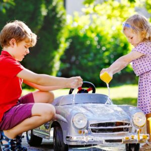 Kids washing toy car.