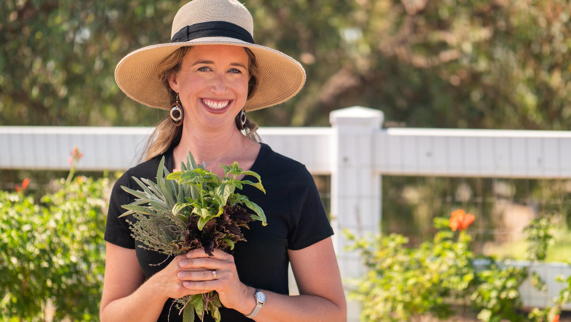 Lisa holding bundle of herbs.