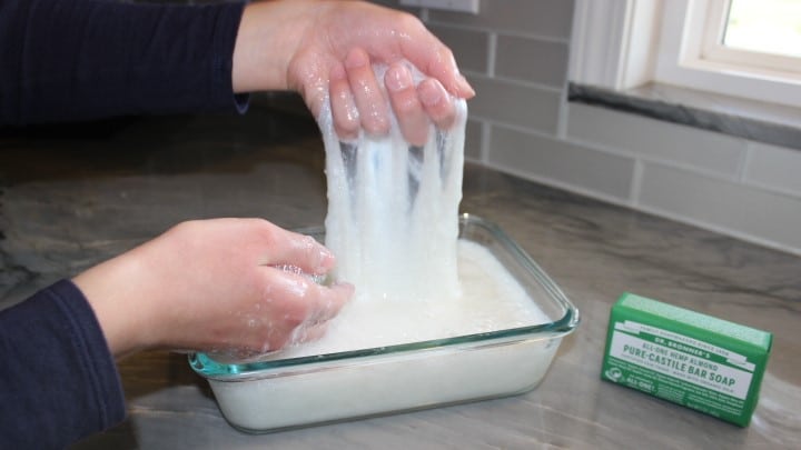 Lisa making bar soap slime in a glass bowl.