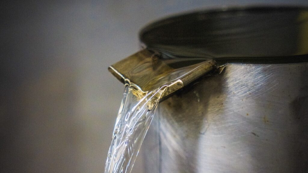 The essential oil flows out of the inverted funnel at the top of the collection vessel. Photo courtesy of Distillerie Bleu Provence.