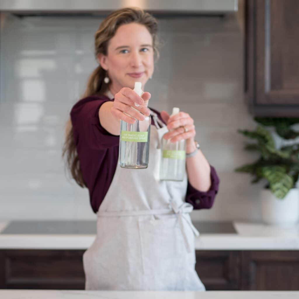 Lisa holding GIY Recipe bottles.