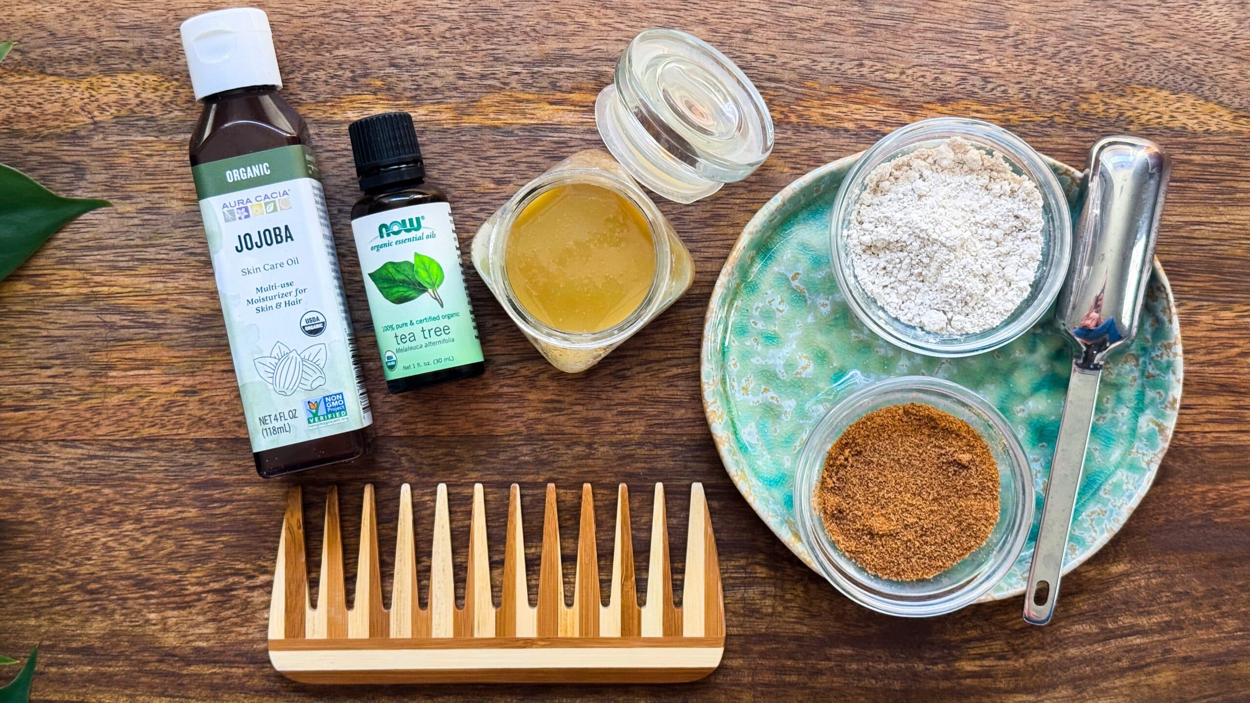 Ingredients for calming scalp scrub including jojoba oil, coconut sugar, colloidal oatmeal, and tea tree oil