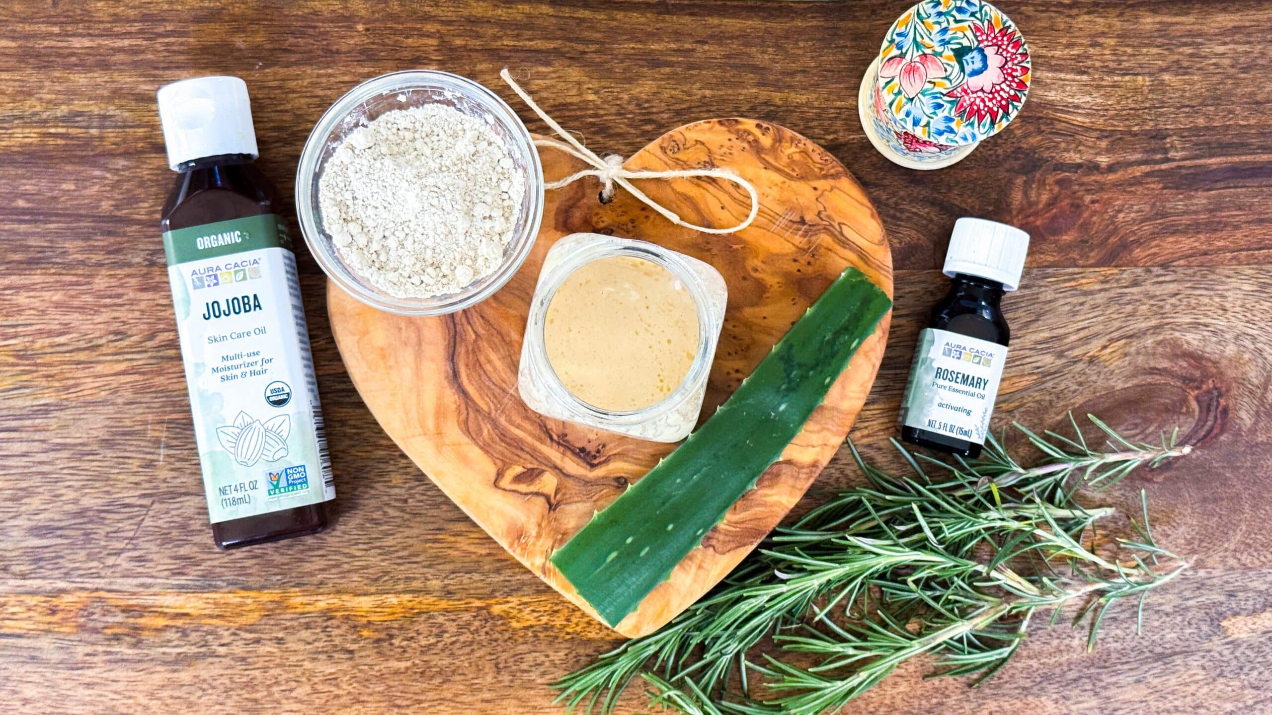 Ingredients for gentle no-scrub scalp treatment including colloidal oatmeal, aloe vera, jojoba oil, and rosemary oil