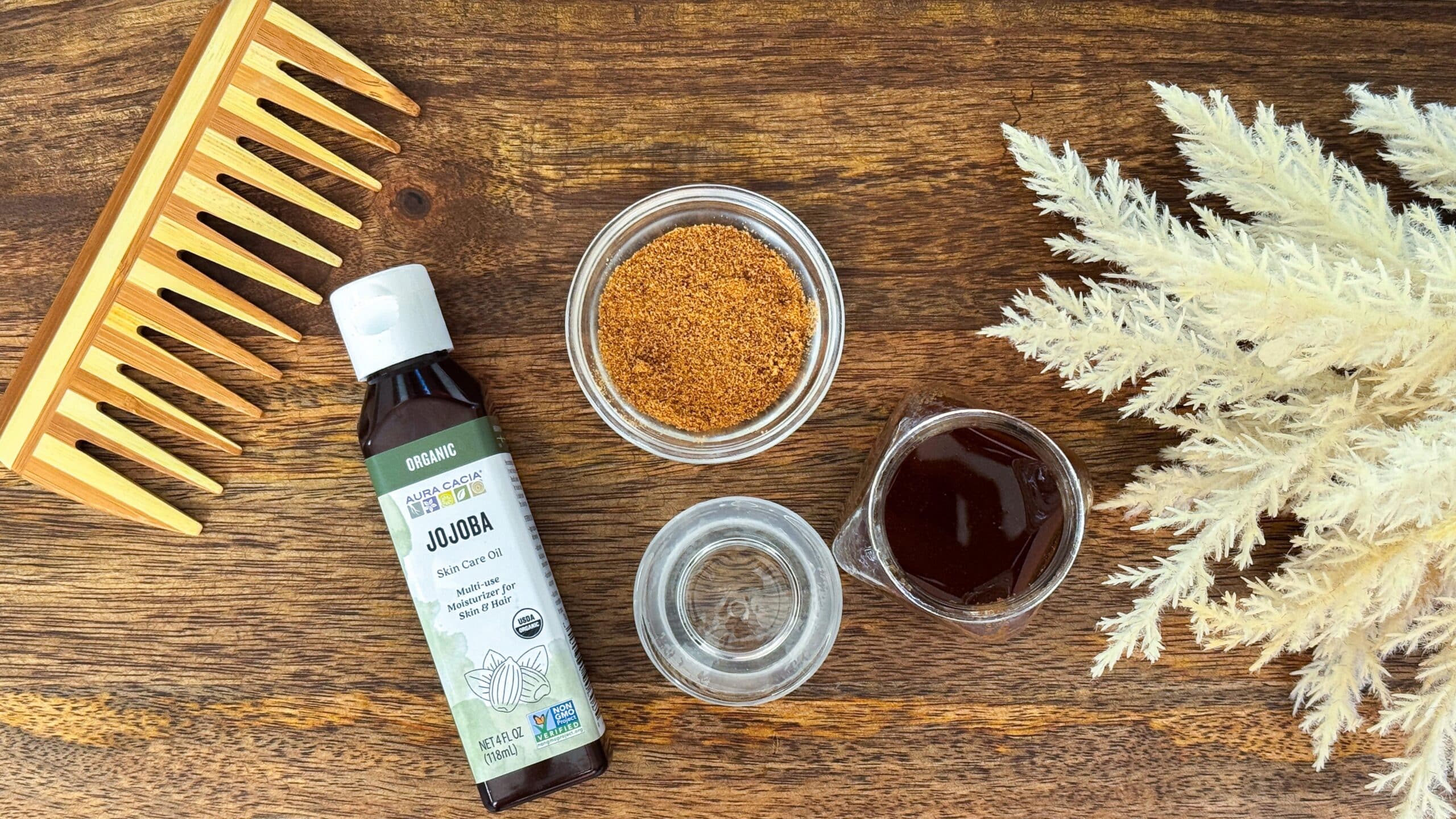 Ingredients for simple scalp scrub including jojoba oil, coconut sugar