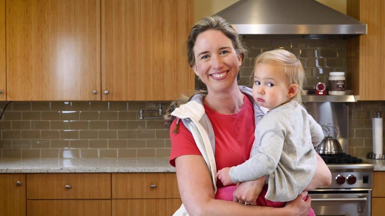 Lisa holding baby while making GIY Baby Wipes